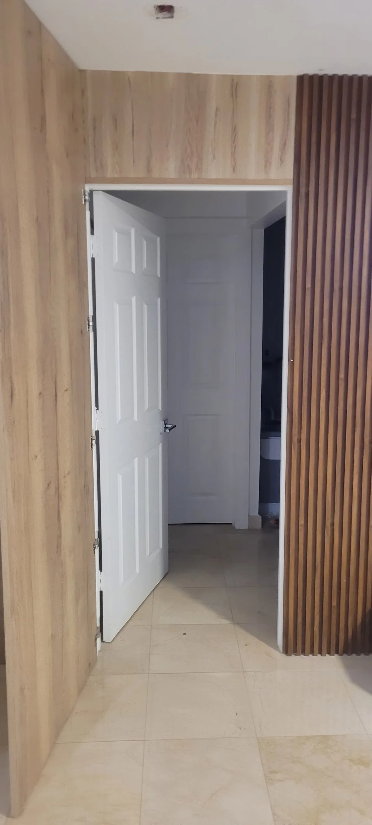 Wood slat accent wall beside an interior door